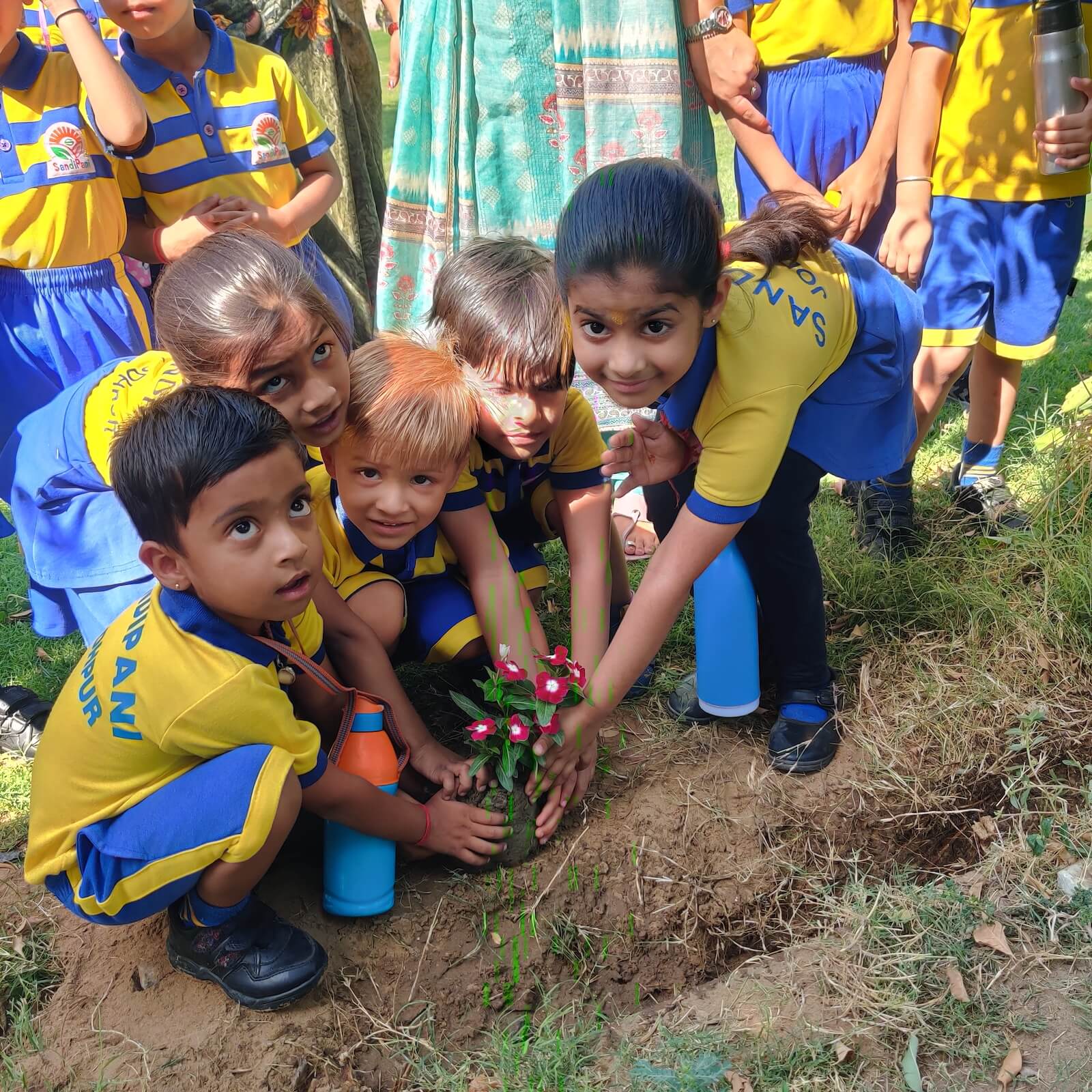 Children at Sandipani Play School planting flowers together